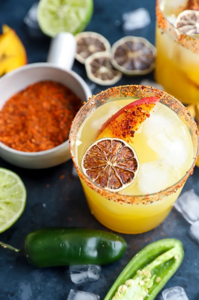 Spicy mango margarita in cocktail glass with jalapenos