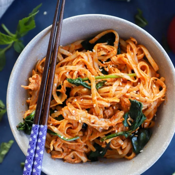 Gochujang Noodles with Chicken and Spinach in a bowl with chopsticks