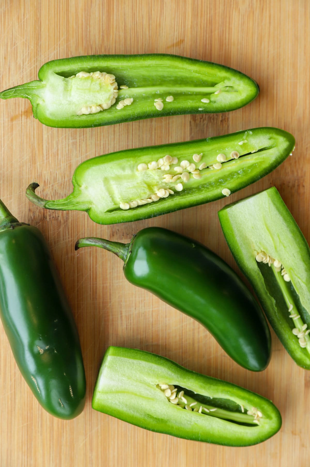 Overhead image of jalapeno peppers on cutting board