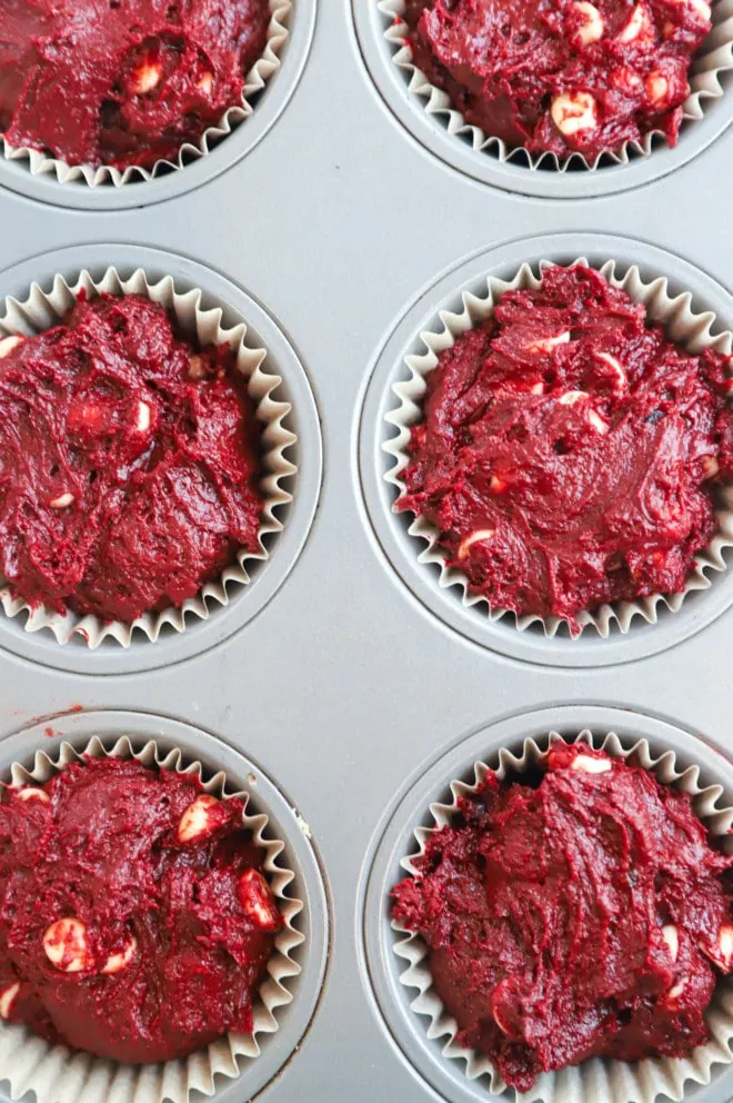 Red velvet muffin batter in muffin tin