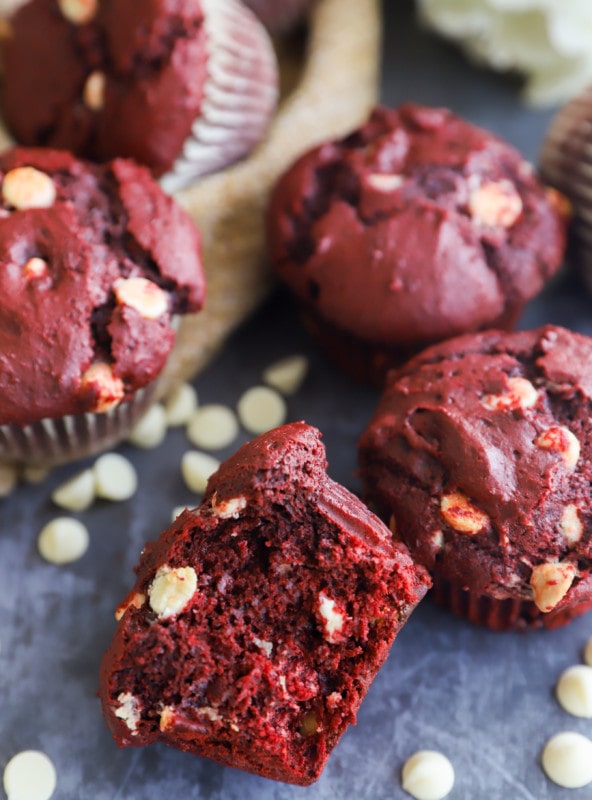 Half of a red velvet muffin with white chocolate chips