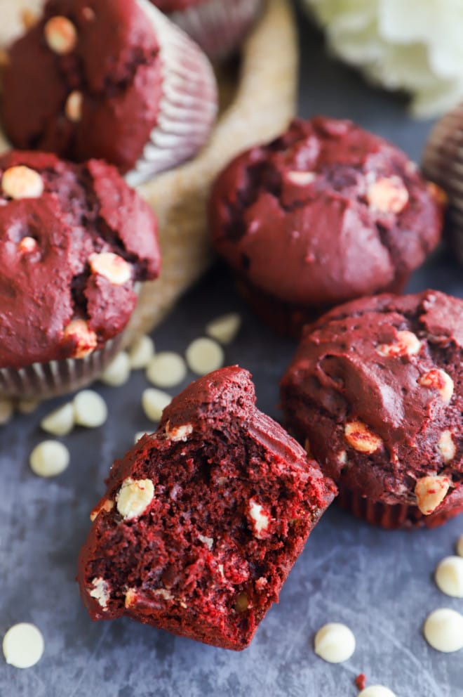 Half of a red velvet muffin with white chocolate chips