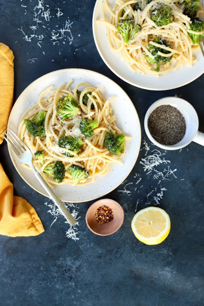 Overhead image of plated bucatini cacio e pepe with broccoli