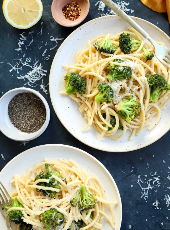 Bucatini cacio e pepe on plates with broccoli image