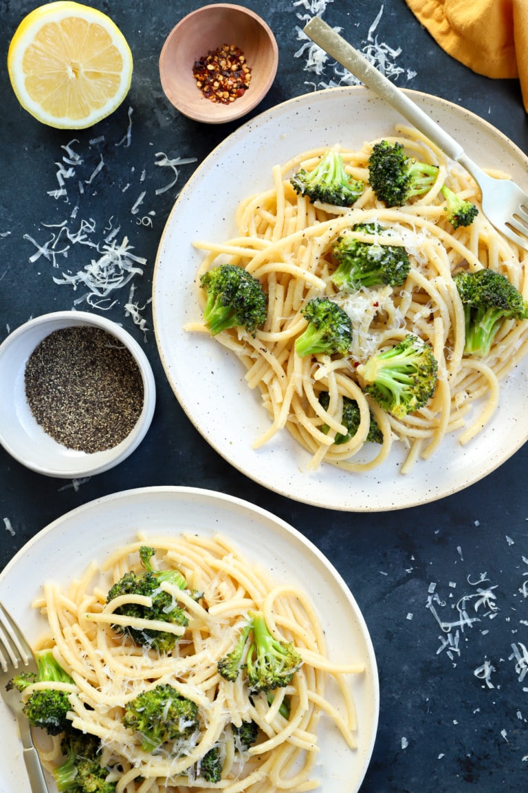 Bucatini cacio e pepe on plates with broccoli image