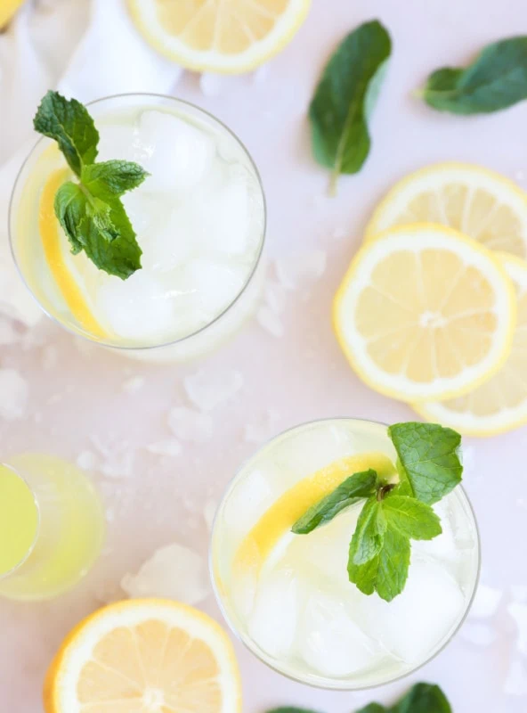 Overhead image of cocktail with lemon and prosecco