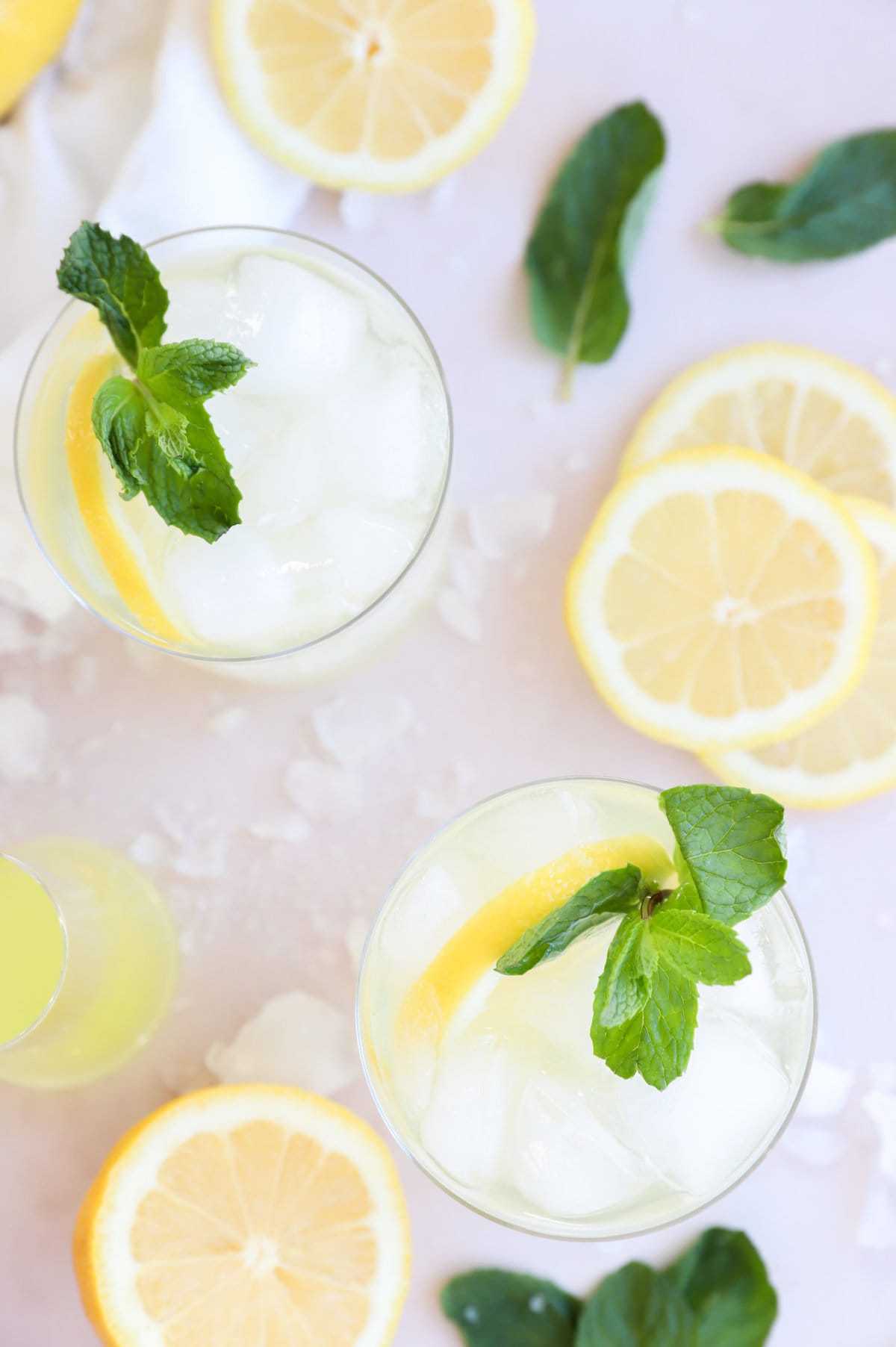 Overhead image of cocktail with lemon and prosecco