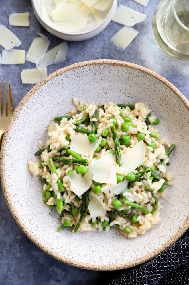 Overhead image of risotto with asparagus and peas in a bowl