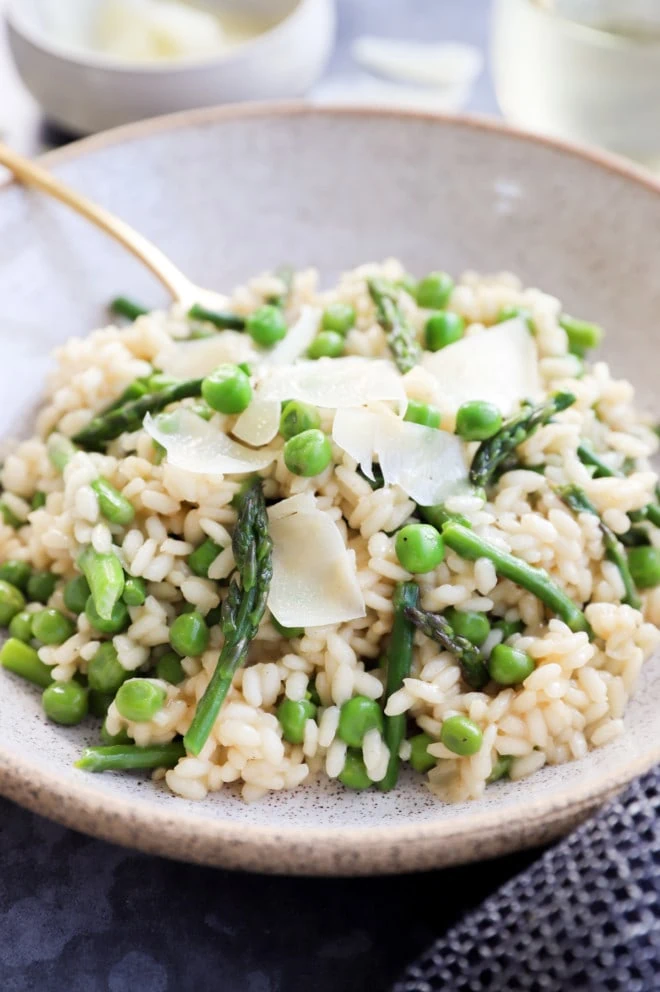 Image of risotto with asparagus and peas in a bowl with fork
