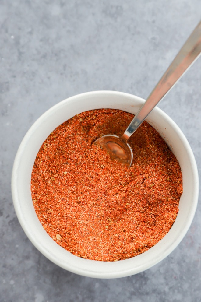 Picture of a small bowl with spoon in chicken taco seasoning mix