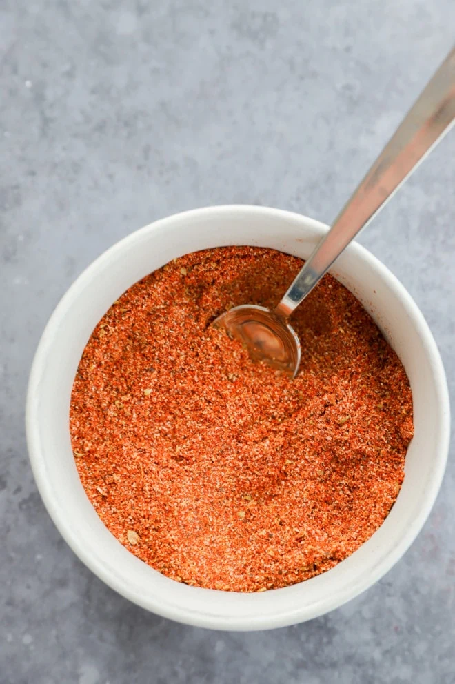 Picture of a small bowl with spoon in chicken taco seasoning mix