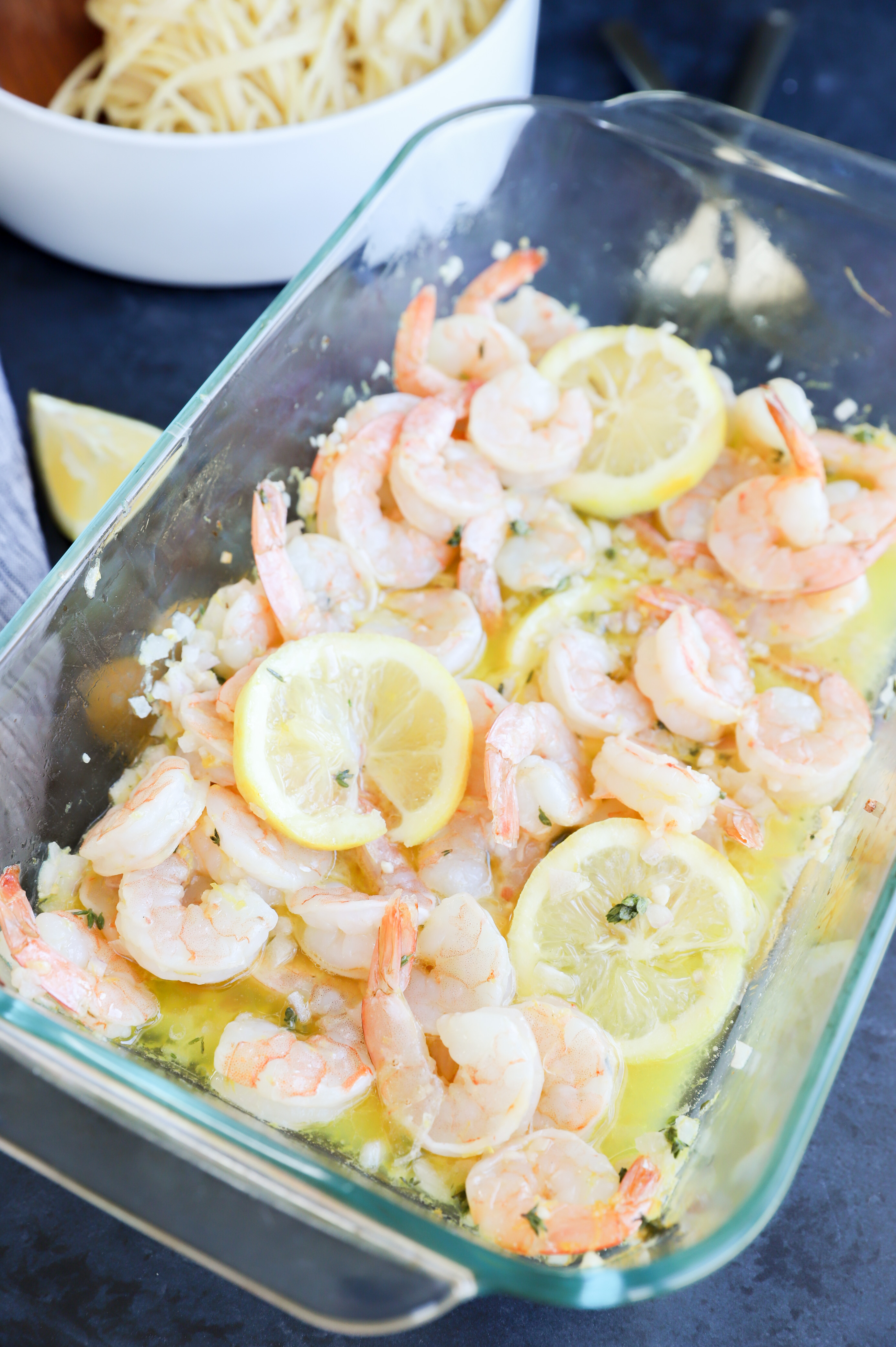 Roasted garlic shrimp with lemon slices in baking dish image