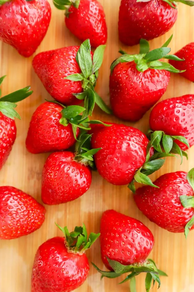 overhead photo of strawberries on cutting board