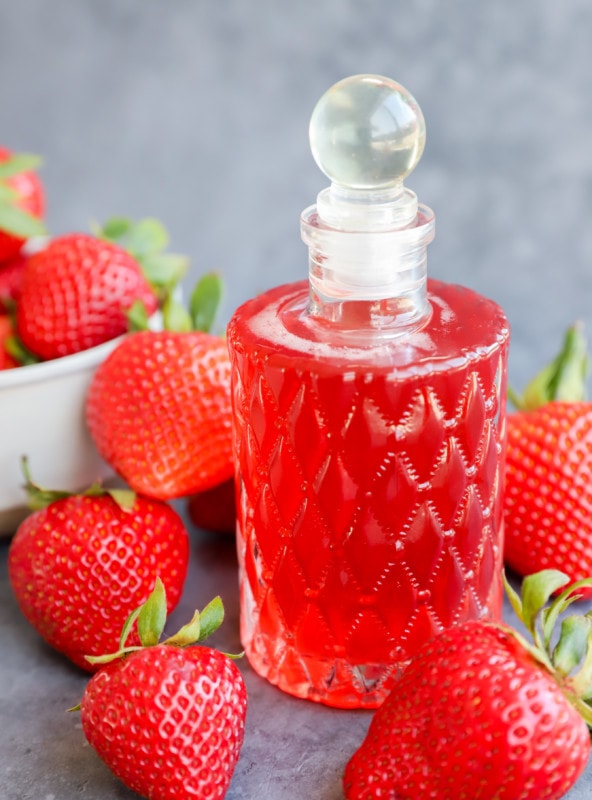 Image of fruity simple syrup in bottle with fruit