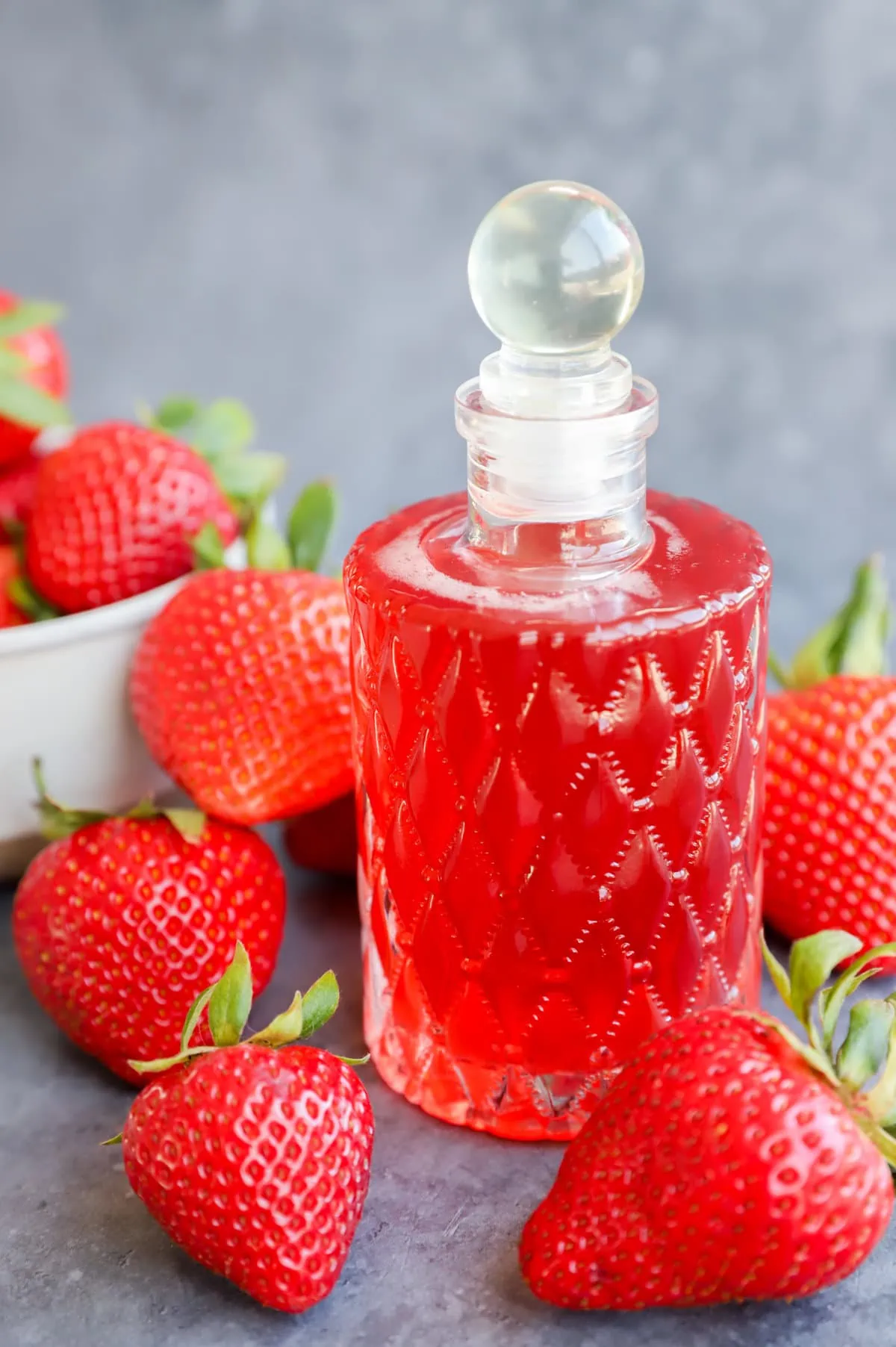 Image of fruity simple syrup in bottle with fruit