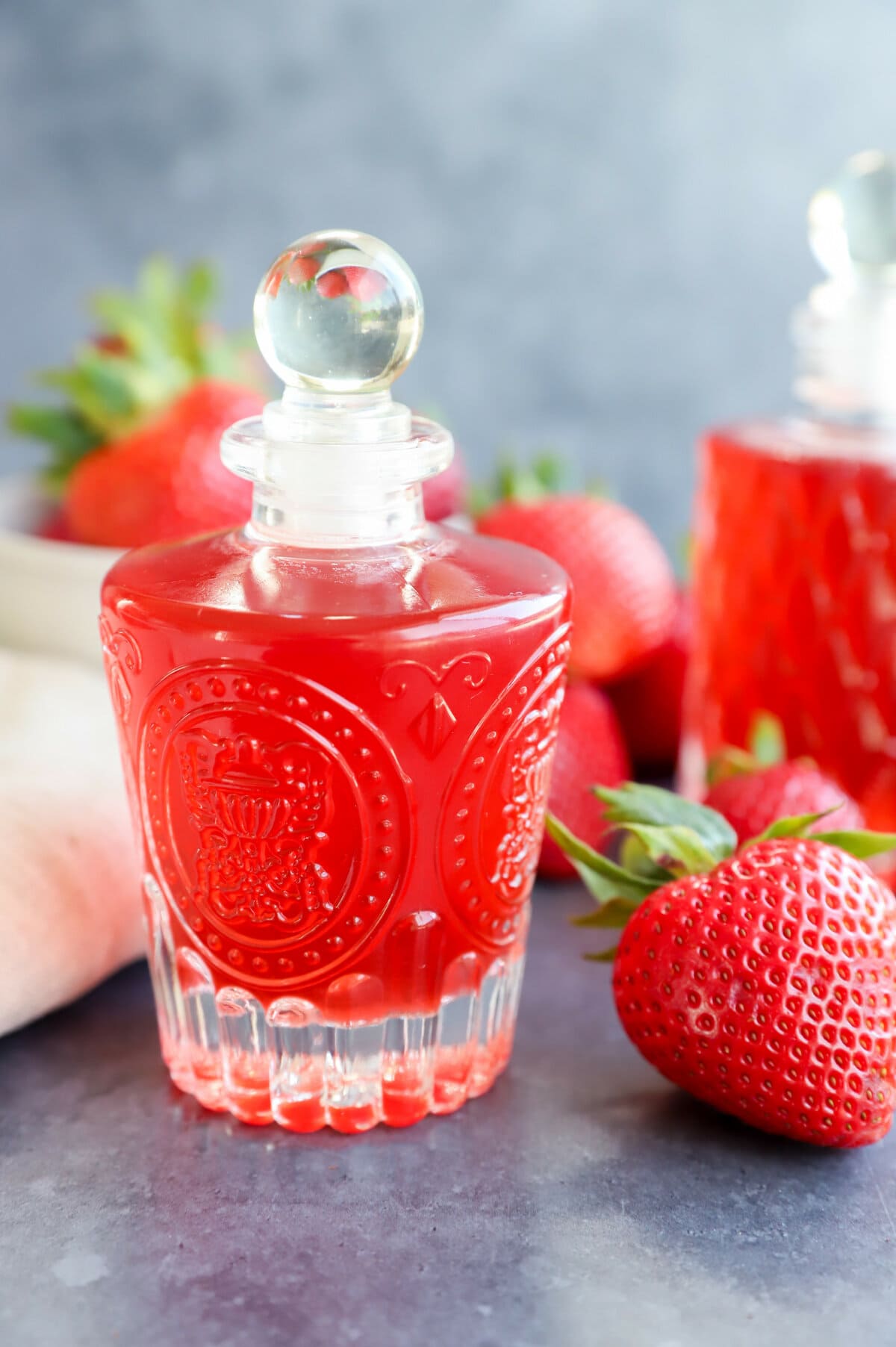 strawberry simple syrup in bottles with fresh berries image