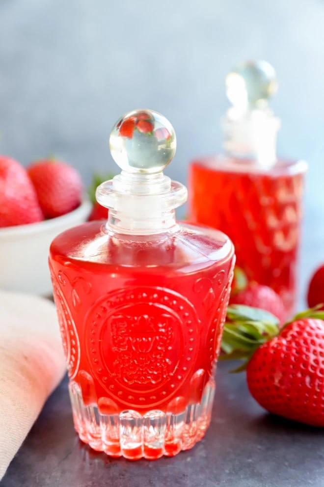 Photo of syrup in bottles with fresh fruit