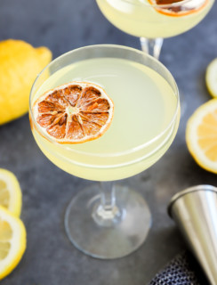 Lemon drop martini cocktails in glasses with jigger image