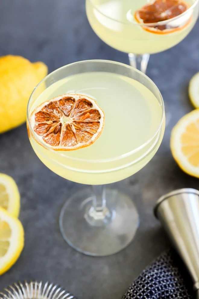 Lemon drop martini cocktails in glasses with jigger image