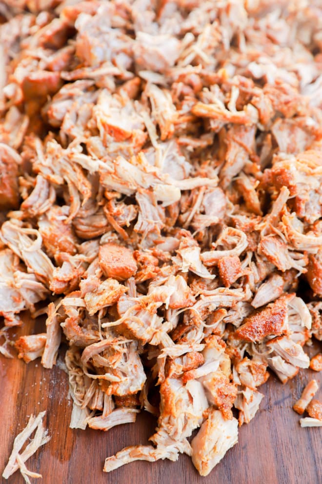 Cooked shredded pork on cutting board image