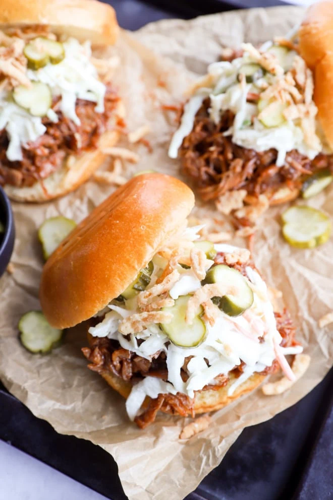 Image of pulled pork burger with parchment paper on sheet pan