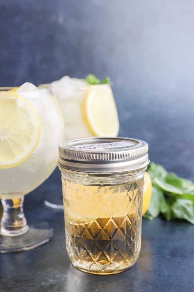 Jar of basil simple syrup with basil lemon cocktails image