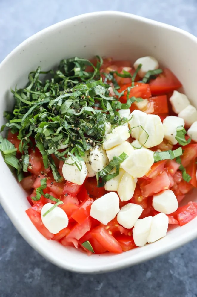 Picture of caprese bruschetta in a bowl before stirring