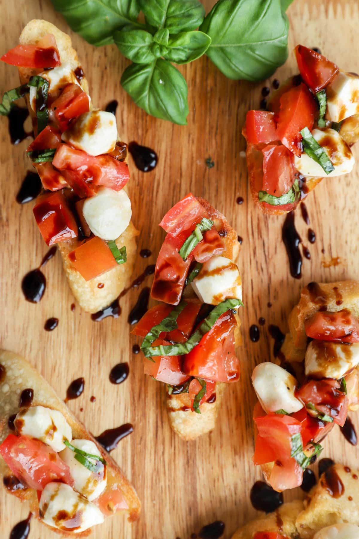 Caprese bruschetta on serving platter overhead image