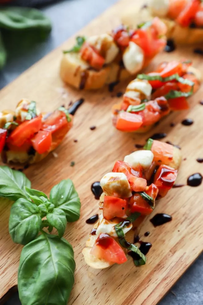 Picture of bruschetta on platter with fresh basil