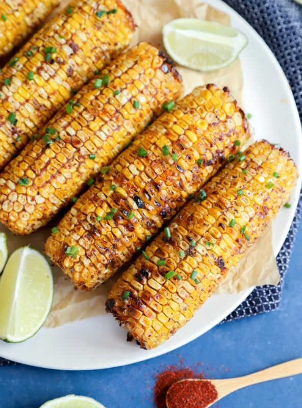 Overhead image of charred blackened corn on a plate