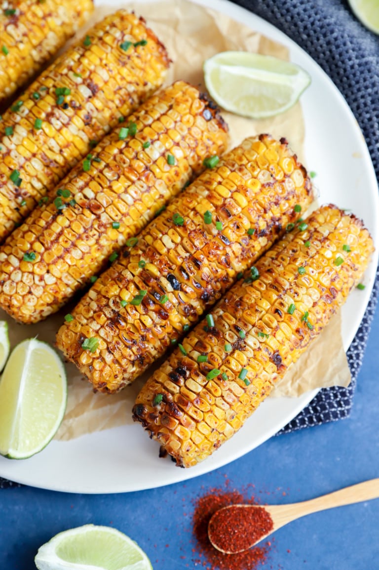 Overhead image of charred blackened corn on a plate