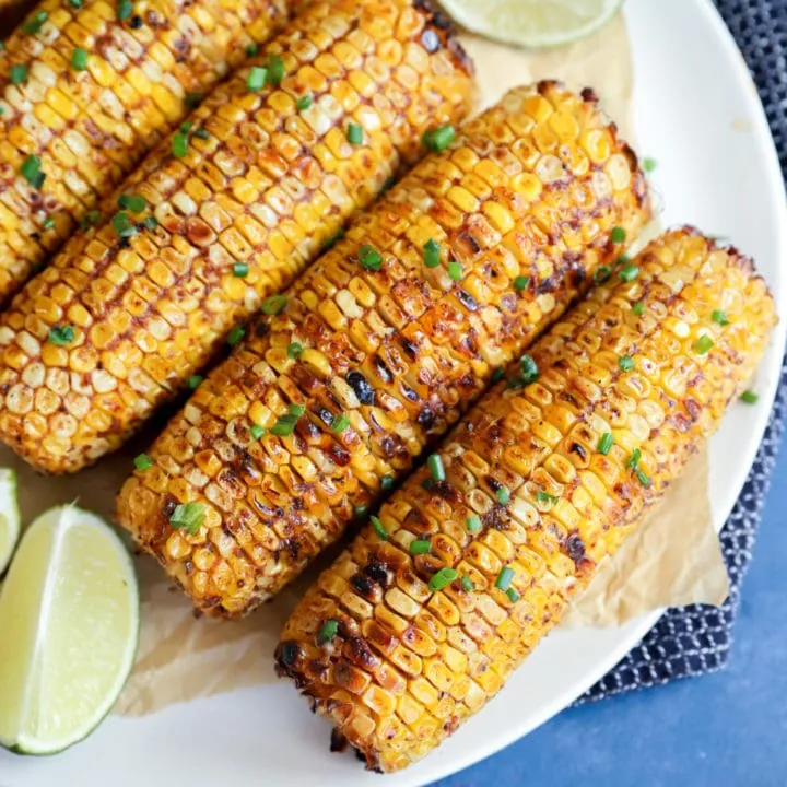 Overhead image of charred blackened corn on a plate