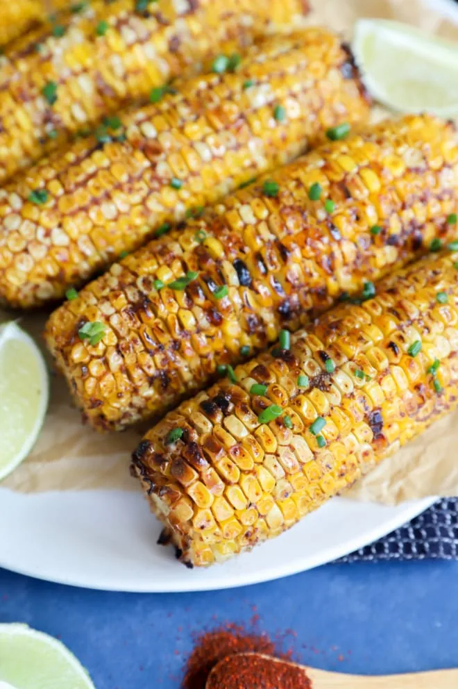 Picture of blackened corn on a platter with lime