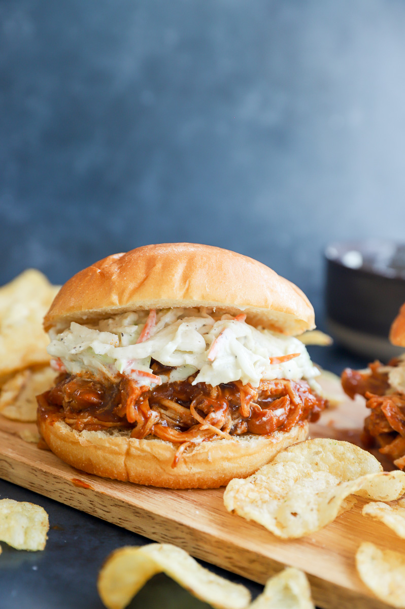 BBQ poultry sandwich with coleslaw on top image