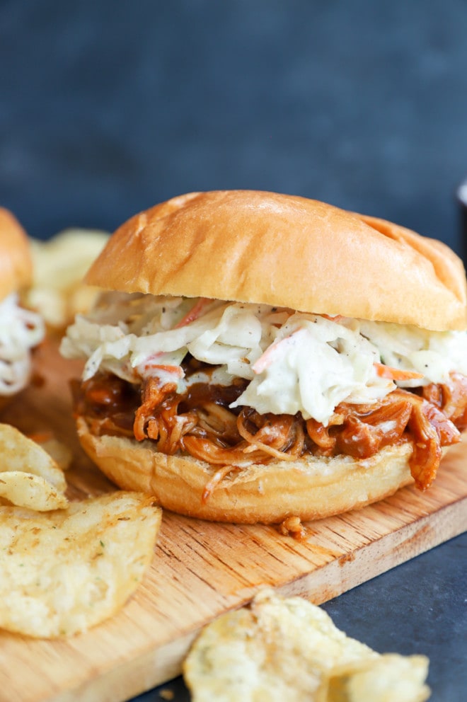 Chicken sandwich and chips on a platter image