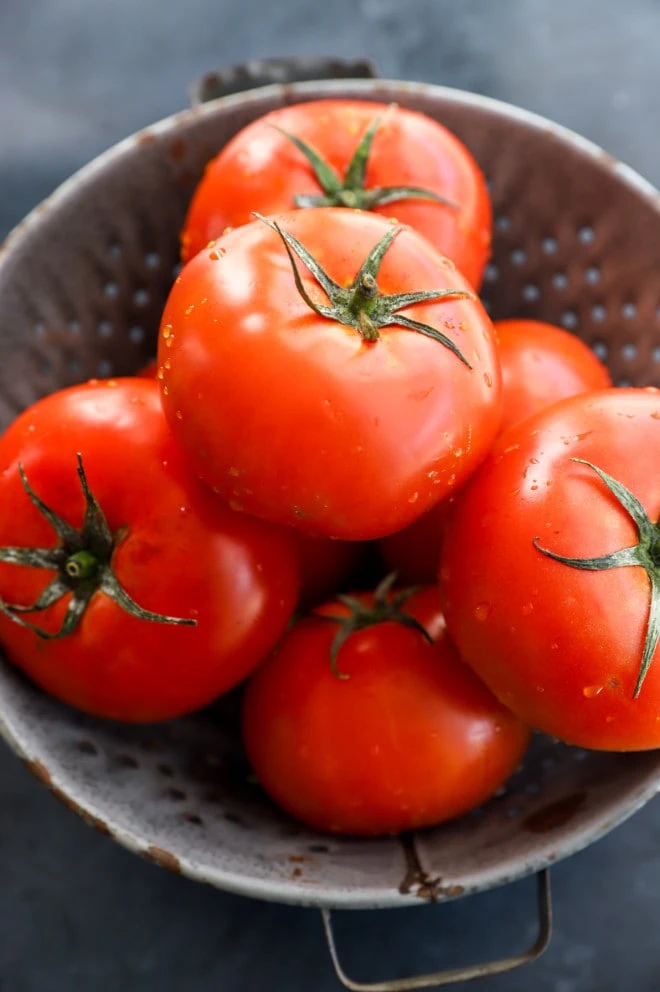 Fresh tomatoes in a colander image