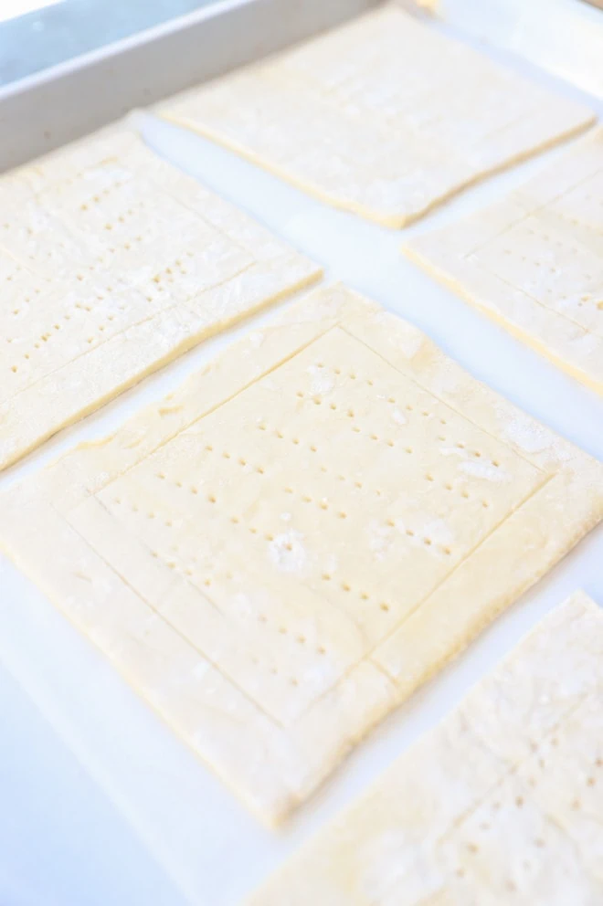 Pieces of puff pastry on a baking sheet image