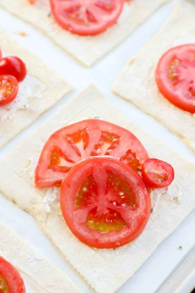 Tomato tart with fresh slices of tomatoes and cream cheese mixture image