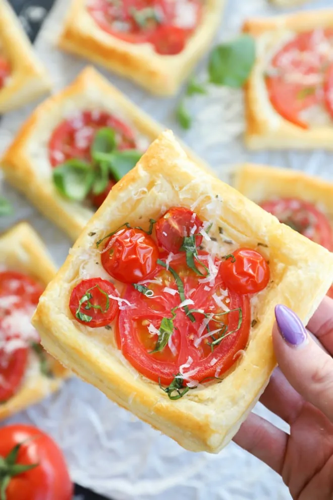 Hand holding tart made with puff pastry and fruit image