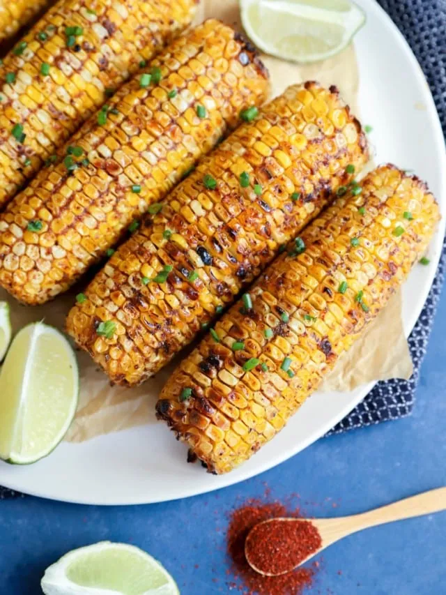 Overhead image of charred blackened corn on a plate