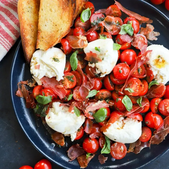 Burrata caprese salad image on platter