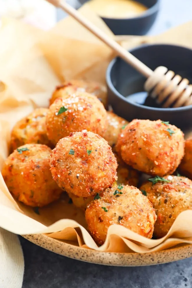 Fried balls drizzled with honey in bowl image