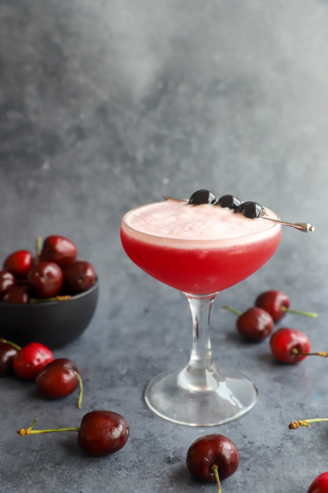 Cherry vodka sour cocktail in coupe glass