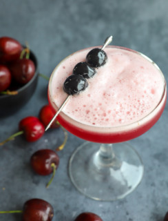 Cherries garnishing a cherry cocktail with vodka