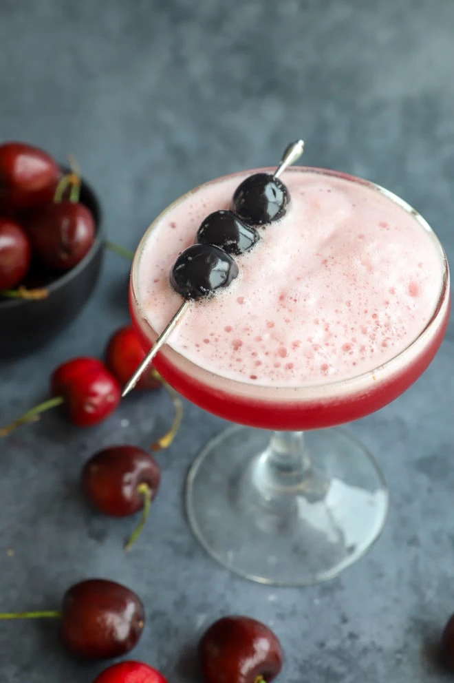 Cherries garnishing a cherry cocktail with vodka