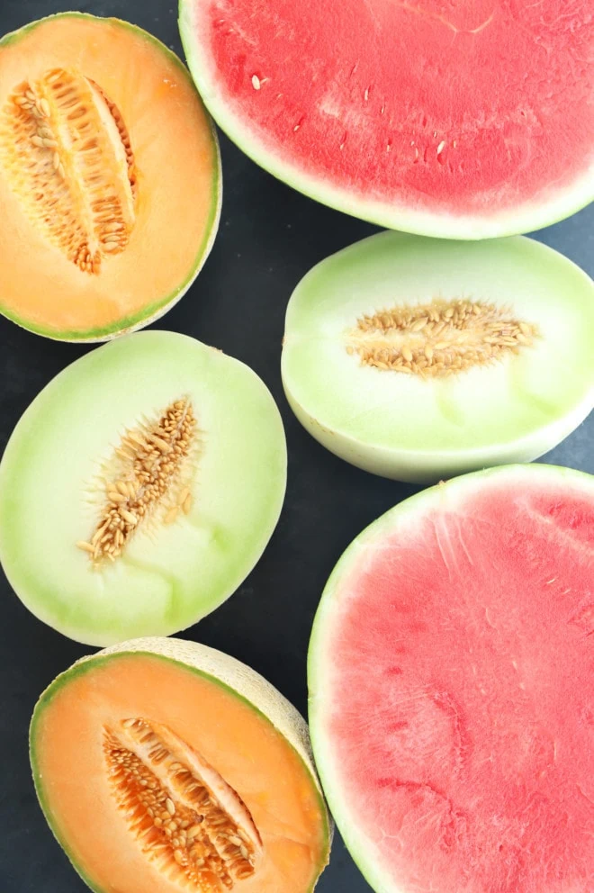 Watermelon cantaloupe and honeydew cut in half picture
