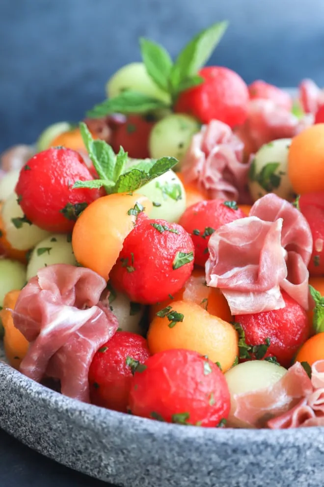 Picture of fruit salad with herb dressing on platter