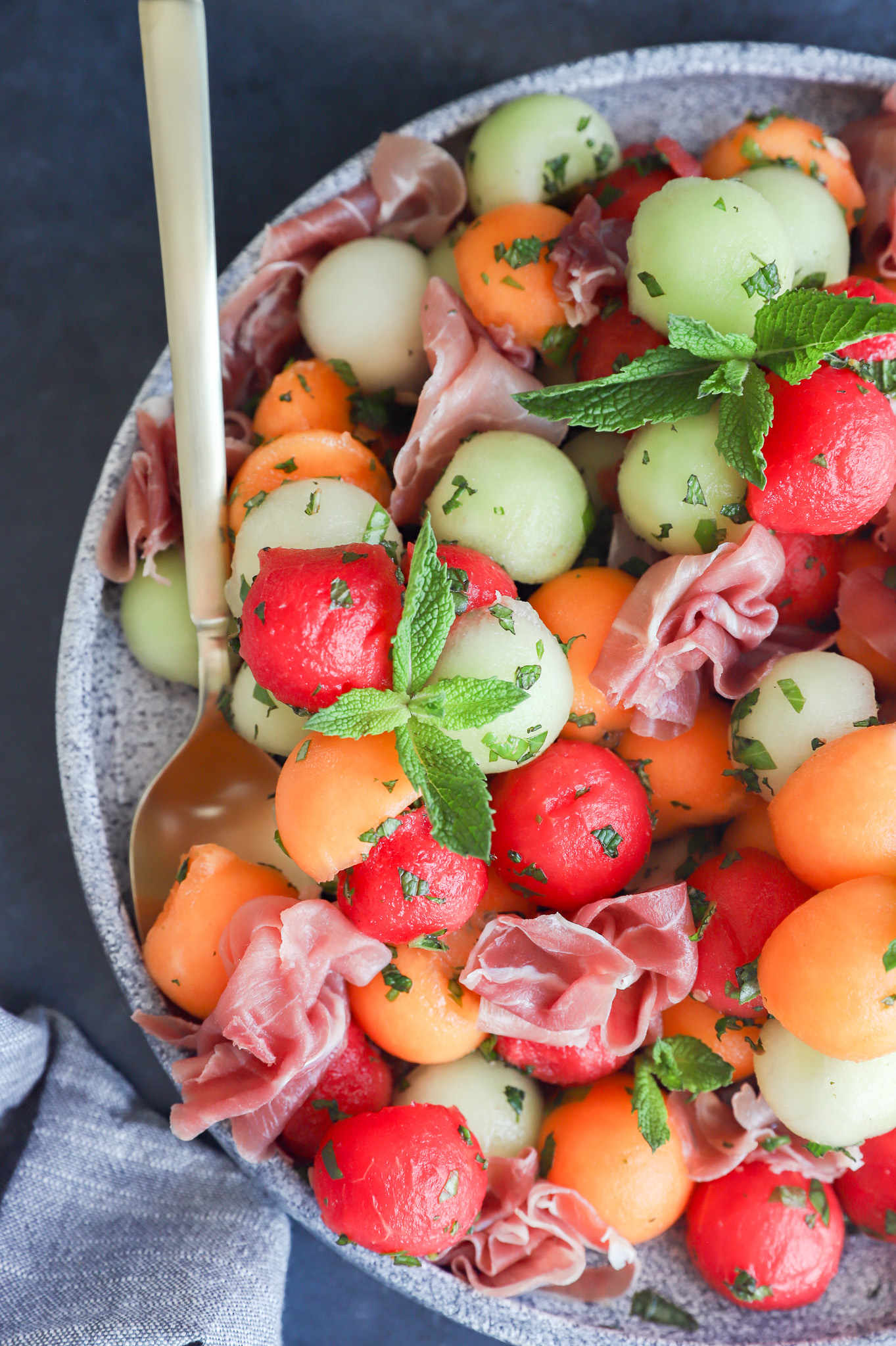 Melon prosciutto salad on platter overhead image