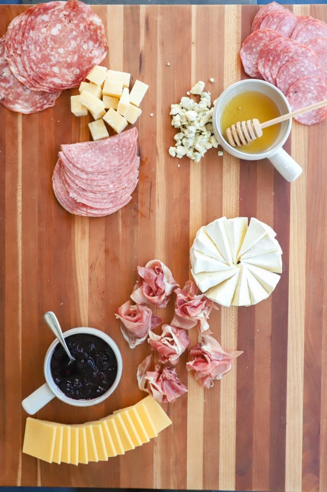 Building a cheese platter with honey and meat