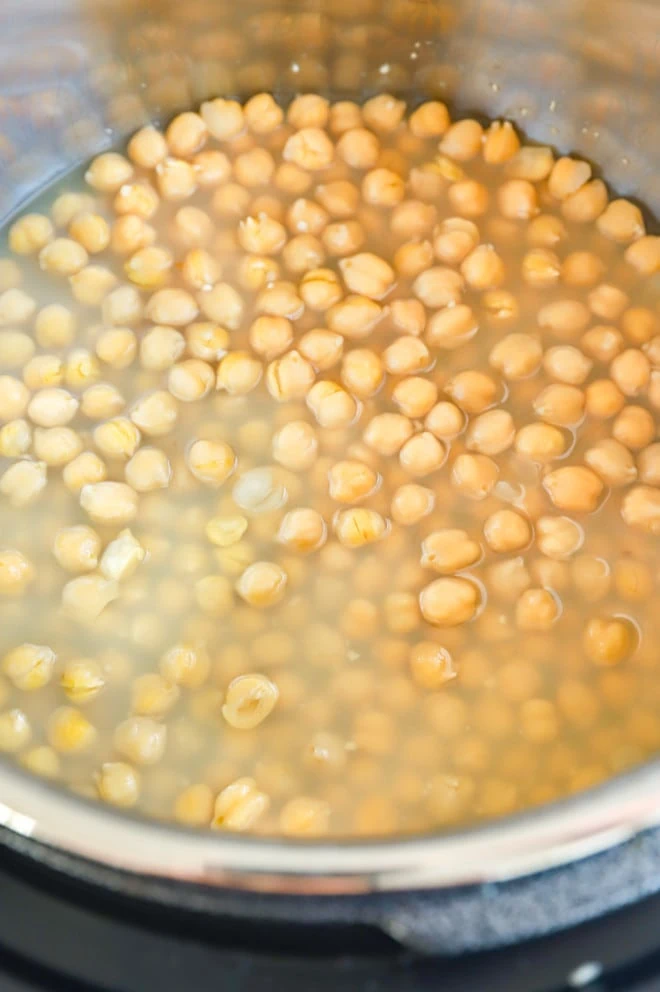 Chickpeas and garlic in an Instant Pot ready to be cooked
